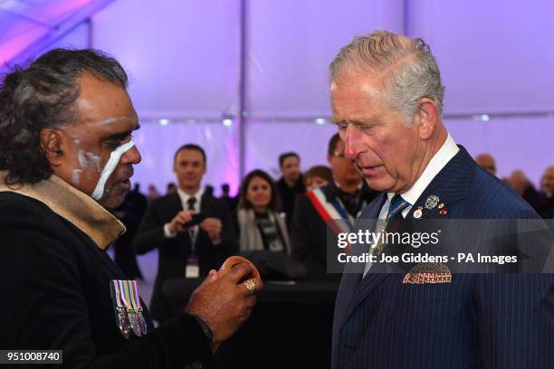 The Prince of Wales meets indigenous didgeridoo player David Dahwurr Hudson after an early morning memorial at the Villers-Bretonneux Memorial in...