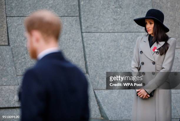 Britain's Prince Harry and his US fiancee Meghan Markle attend an Anzac Day dawn service at Hyde Park Corner on April 25, 2018 in London, England....