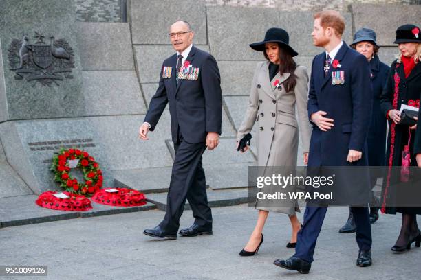 Britain's Prince Harry and his US fiancee Meghan Markle walk with New Zealand's High Commissioner to the United Kingdom, Jerry Mateparae, during...