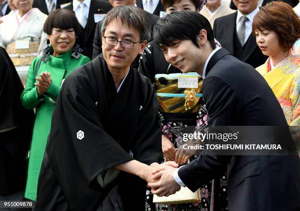 Men's figure skating gold medallist from the Pyeongchang Winter Olympic Games, Yuzuru Hanyu , shakes hands with shogi professional title holder...