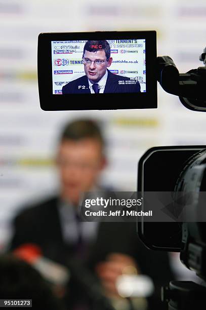 Craig Levein is viewed through a camera monitor as he is unveiled as the new Scotland football coach by Gordon Smith and George Peat at Hampden Park...