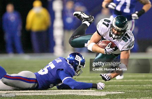 Tight end Brent Celek of the Philadelphia Eagles is tackled by linebacker Danny Clark of the New York Giants during a game on December 13, 2009 at...