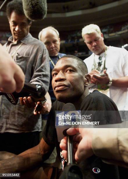 Dikembe Mutombo of the Philadelphia 76ers talks to the media after practice for the NBA Finals 14 June 2001 at First Union Center in Philadelphia,...