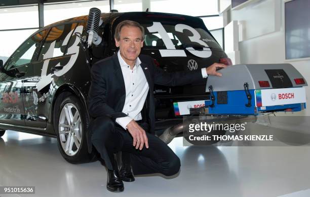 Volkmar Denner, CEO of German electronic and engineering company Bosch, poses next to a testcar prior to the company's annual press conference at the...