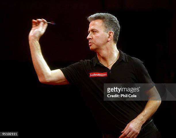 Magnus Caris of Sweden in action against Fransisco Ruiz of Spain during the 2010 Ladbrokes.com World Darts Championship Round One at Alexandra Palace...