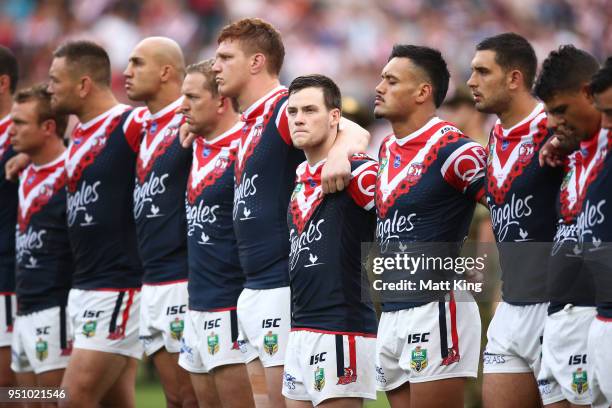 Luke Keary of the Roosters and team mates stand to commemorate Anzac Day during the round eight NRL match between the St George Illawara Dragons and...