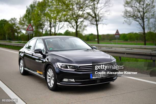 Converted Volkswagen Passat car drives as artificial intelligence takes over driving the car during tests of autonomous car abilities conducted by...