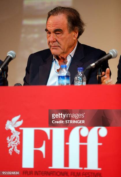 Film director Oliver Stone speaks at a press conference during the Fajr Film festival in the Iranian capital Tehran on April 25, 2018. - The...