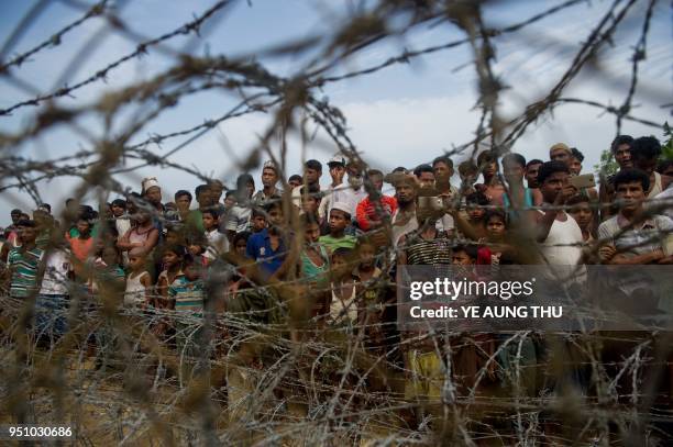 Rohingya refugees gather in the "no man's land" behind Myanmar's boder lined with barb wire fences in Maungdaw district, Rakhine state bounded by...