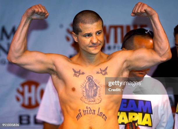 Former four time world champion Johnny Tapia poses on the scales as he weighs-in at 124lbs at the MGM Grand Hotel in Las Vegas, Nevada 06 October,...