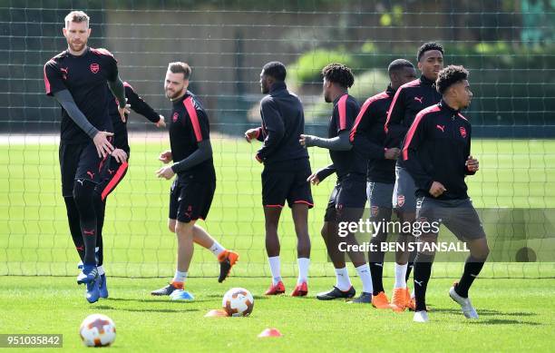 Arsenal's German defender Per Mertesacker , Arsenal's English defender Calum Chambers and Arsenal's English midfielder Reiss Nelson attends a...