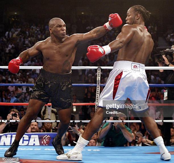 Challenger Mike Tyson of the US swings at Heavyweight Champion Lennox Lewis of England during the 1st round of their World Heavyweight Championship...