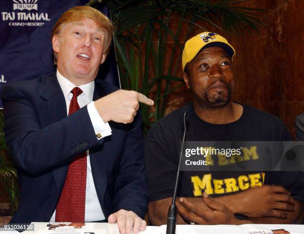 Heavyweight challenger Ray Mercer , of New Jersey, listens to developer and hotel owner Donald Trump before a press conference 11 June 2002 to...