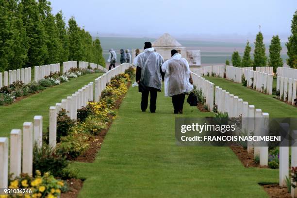 Photo taken on April 25, 2018 shows people visiting the Australia - New Zealand military cemetery in Villers-Bretonneux, northern France, during...