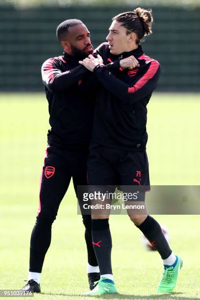 Alexandre Lacazette of Arsenal and Hector Bellerin of Arsenal joke with each other ahead of an Arsenal Training session ahead of their Europa League...