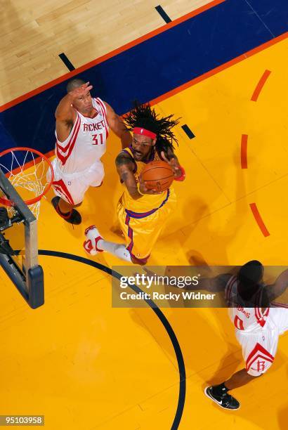 Mikki Moore of the Golden State Warriors looks to score against Shane Battier of the Houston Rockets during the game on December 3, 2009 at Oracle...