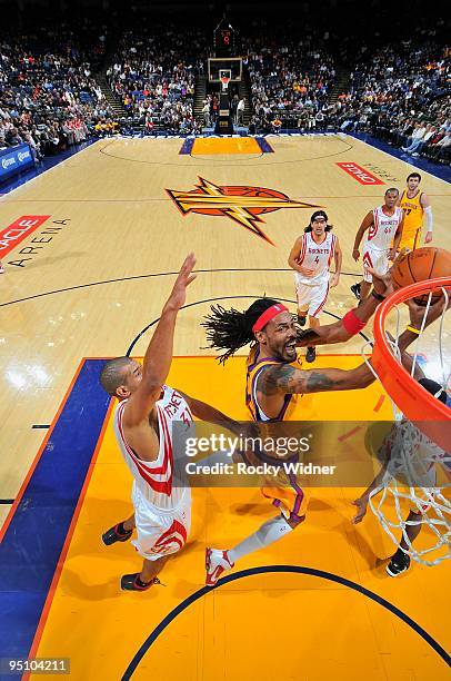 Mikki Moore of the Golden State Warriors looks to score against Shane Battier of the Houston Rockets during the game on December 3, 2009 at Oracle...