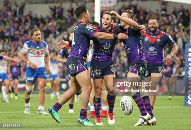 Ryley Jacks of the Melbourne Storm is congratulated by Billy Slater and his teammates after scoring a try during the round eight NRL match between...