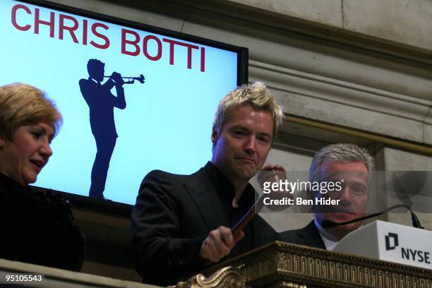 Musician Chris Botti and Chief Executive Officer of the NYSE Duncan Niederauer ring the closing bell at the New York Stock Exchange on December 23,...