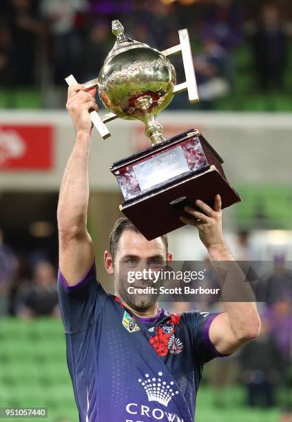 Cameron Smith of the Melbourne Storm holds the Michael Moore trophy after winning the round eight NRL match between the Melbourne Storm and New...