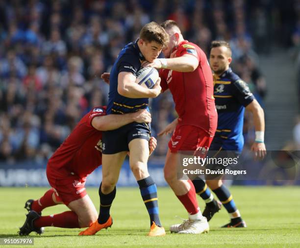 Garry Ringrose of Leinster is tackled during the European Rugby Champions Cup Semi-Final match between Leinster Rugby and Scarlets at Aviva Stadium...