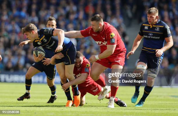 Garry Ringrose of Leinster is tackled during the European Rugby Champions Cup Semi-Final match between Leinster Rugby and Scarlets at Aviva Stadium...