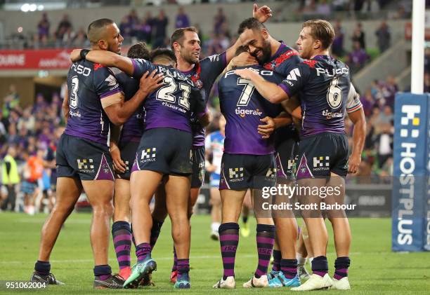 Ryley Jacks of the Melbourne Storm is congratulated by Cameron Smith and his teammates after scoring a try during the round eight NRL match between...