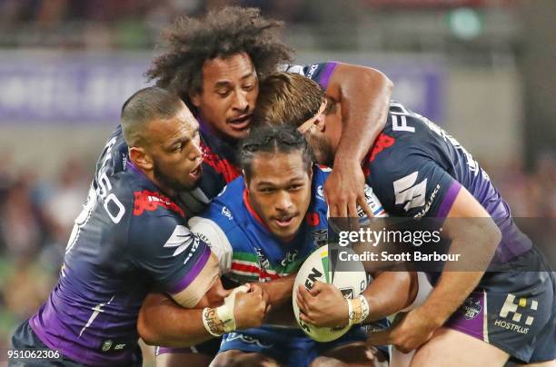 Agnatius Paasi of the Warriors is tackled during the round eight NRL match between the Melbourne Storm and New Zealand Warriors at AAMI Park on April...
