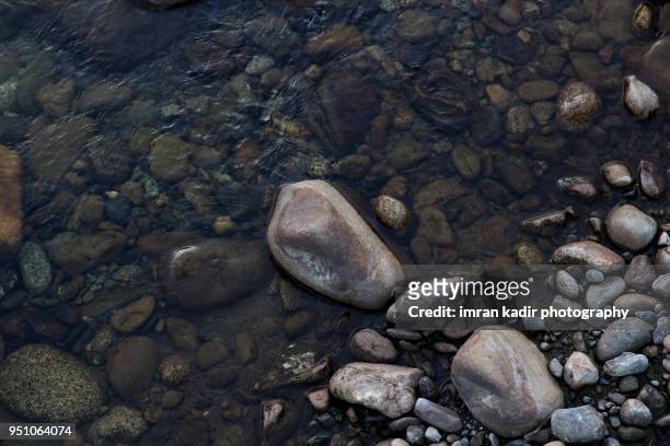 rock textures in the river - minirock stock pictures, royalty-free photos & images