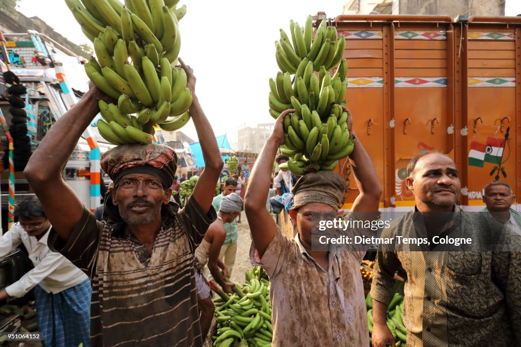 Market vendors at a banana auction, India