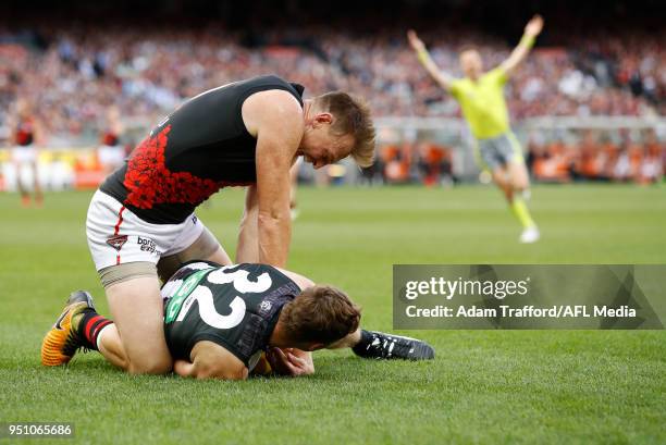 Brendon Goddard of the Bombers tackles Will Hoskin-Elliott of the Magpies during the 2018 AFL round five ANZAC Day match between the Collingwood...