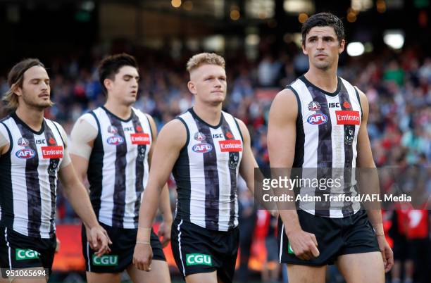 Scott Pendlebury of the Magpies leads the team to the banner run-through during the 2018 AFL round five ANZAC Day match between the Collingwood...