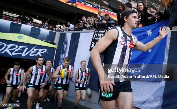 Scott Pendlebury of the Magpies leads his team up the race during the 2018 AFL round five ANZAC Day match between the Collingwood Magpies and the...