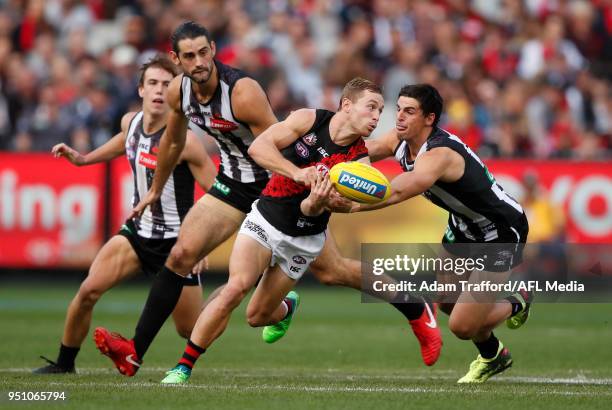 Devon Smith of the Bombers is tackled by Scott Pendlebury of the Magpies during the 2018 AFL round five ANZAC Day match between the Collingwood...