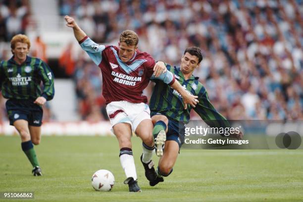 Leeds United player Gary Speed challenges West Ham United player Peter Butler as Gordon Strachan looks on during a Premier League game at Upton Park...
