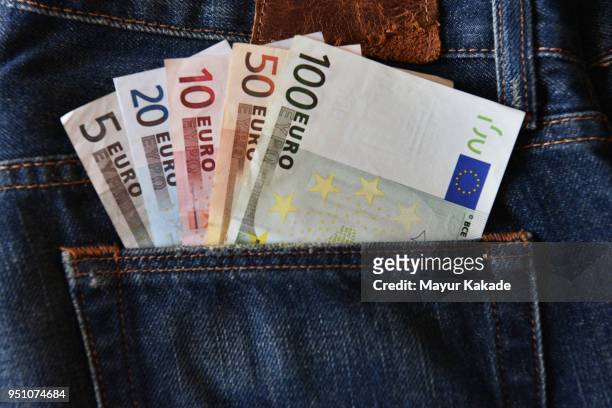 euro currency notes in jeans back pocket - all european currencies stock pictures, royalty-free photos & images