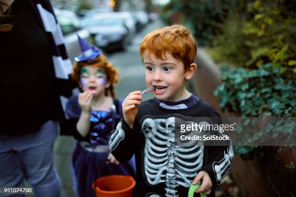 eating halloween candy - stage costume stock pictures, royalty-free photos & images