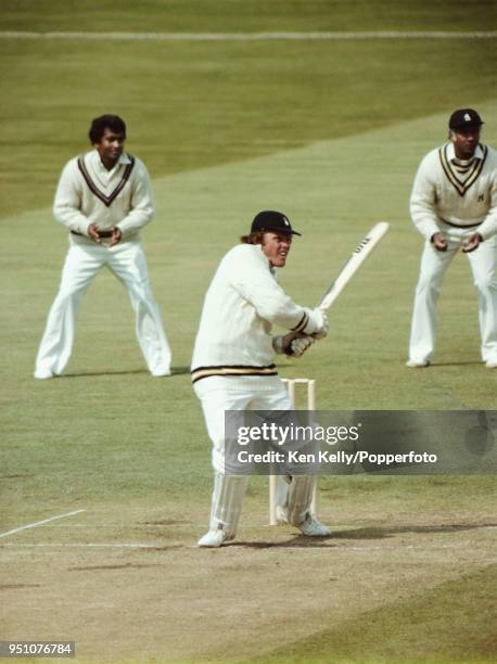 Hampshire batsman Barry Richards pulls a short ball to the boundary watched by Warwickshire fielders Alvin Kallicharran and Rohan Kanhai during a...