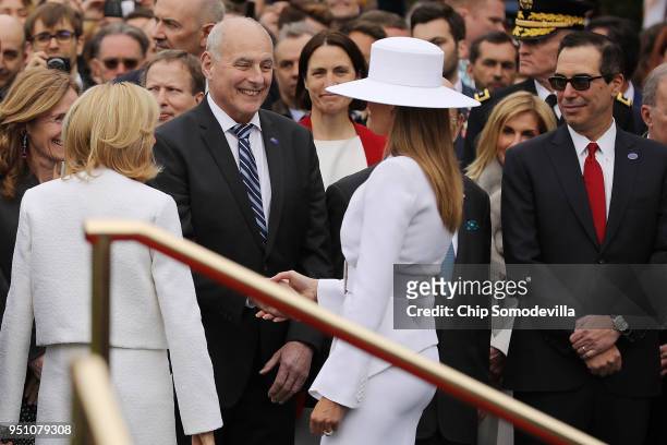 White House Chief of Staff John Kelly and Treasury Secretary Steven Mnuchin greet U.S. First lady Melania Trump and Brigitte Macron, wife of French...