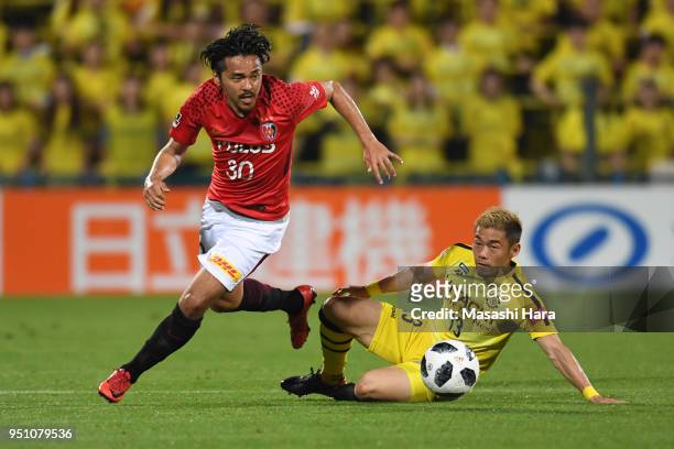 Shinzo Koroki of Urawa Red Diamonds and Ryuta Koike of Kashiwa Reysol compete for the ball during the J.League J1 match between Kashiwa Reysol and...