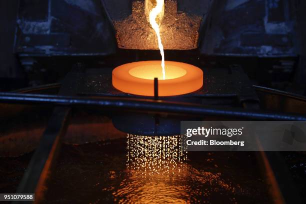 Molten gold flows into water to produce the gold casting grain at the Valcambi SA precious metal refinery in Lugano, Switzerland, on Monday, April...