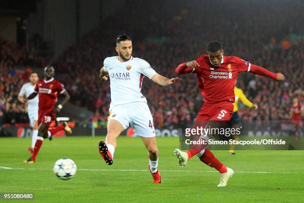 Georginio Wijnaldum of Liverpool shoots past Konstantinos Manolas of Roma during the UEFA Champions League Semi Final First Leg match between...