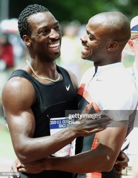 Michael Johnson of the US celebrates with second place finisher Alvin Harrison after Johnson won the Men's 400 meters 16 July, 2000 at the 2000 US...
