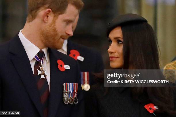 Britain's Prince Harry and his US fiancee Meghan Markle attend a service of commemoration and thanksgiving to mark Anzac Day in Westminster Abbey in...