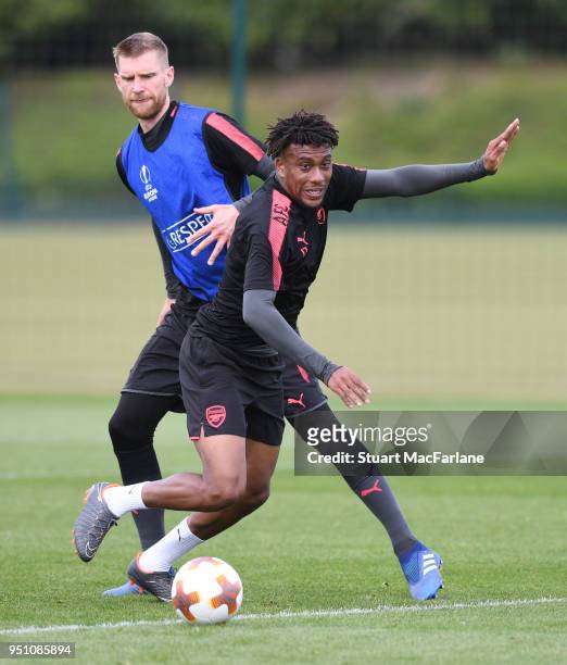 Per Mertesacker and Alex Iwobi of Arsenal during a training session at London Colney on April 25, 2018 in St Albans, England.