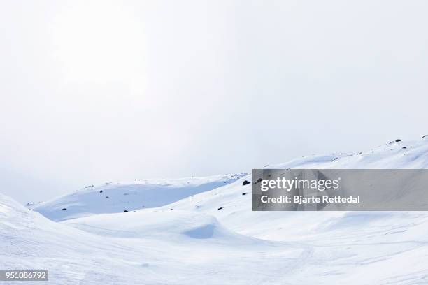 ski tracks in empty mountain landscape - bjarte rettedal stock pictures, royalty-free photos & images