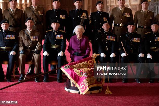 Queen Elizabeth II, Colonel-in-Chief of the Royal Tank Regiment, poses for a photograph after presenting the regiment with their new standard in St...