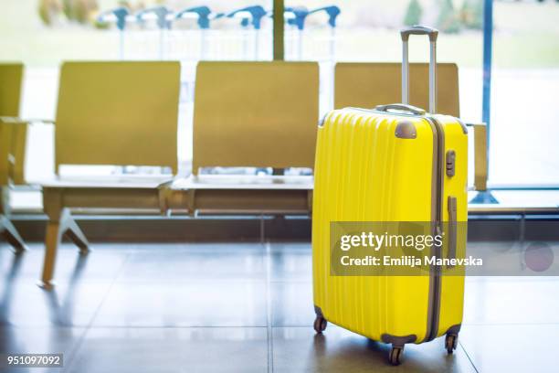 suitcase at airport - yellow suitcase stock pictures, royalty-free photos & images