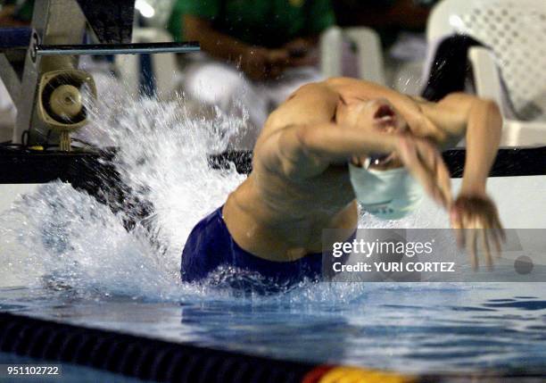 The Mexican Juan Carlos Rodela jumps in the water, 28 November 2002, during his participation in the 100 meter dorso swimming competition of the XIX...