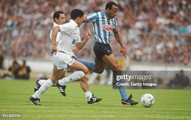 Coventry striker Cyrille Regis holds off the challenge of Spurs players Osvaldo Ardiles and Chris Hughton during the 1987 FA Cup Final between...